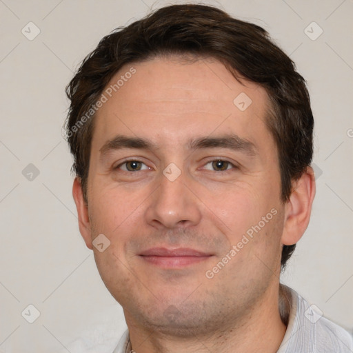 Joyful white adult male with short  brown hair and brown eyes