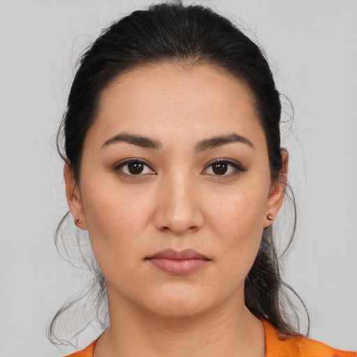 Joyful latino young-adult female with medium  brown hair and brown eyes