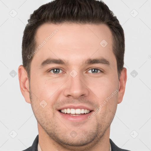 Joyful white young-adult male with short  brown hair and brown eyes