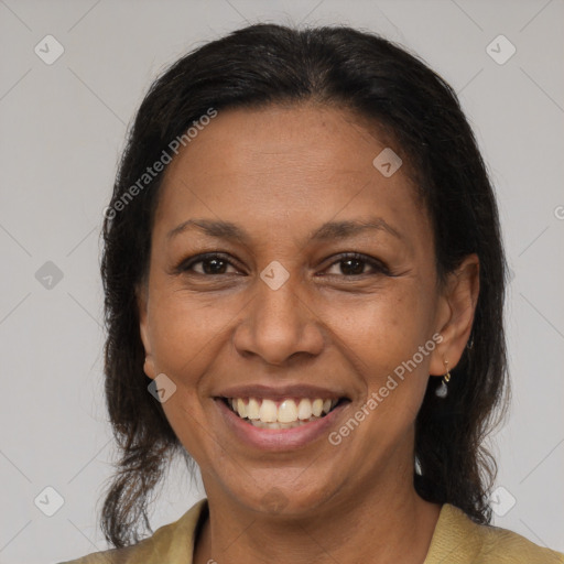 Joyful latino adult female with medium  brown hair and brown eyes