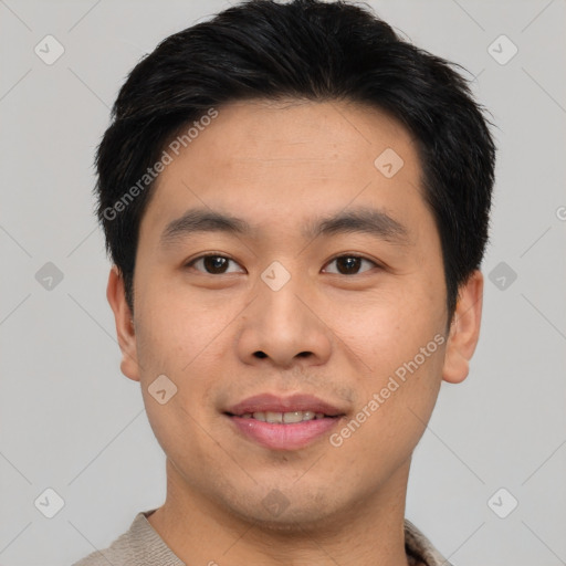 Joyful asian young-adult male with short  black hair and brown eyes