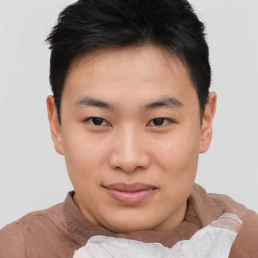 Joyful asian young-adult male with short  brown hair and brown eyes