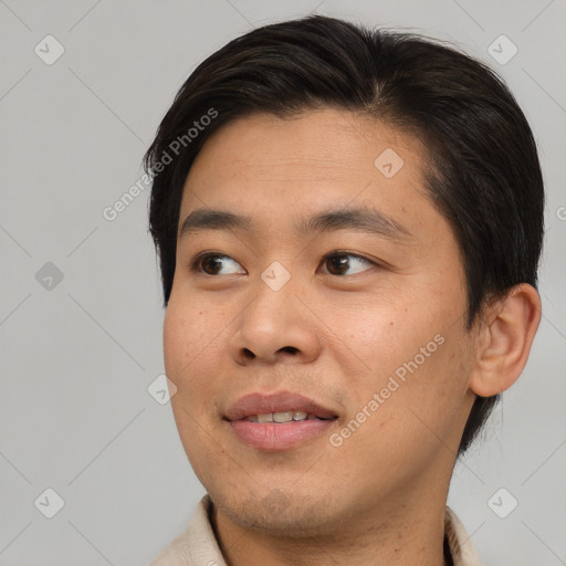 Joyful asian young-adult male with short  black hair and brown eyes