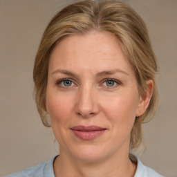 Joyful white adult female with medium  brown hair and blue eyes