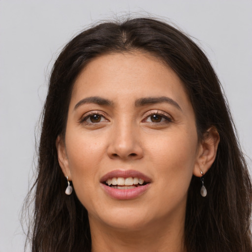 Joyful white young-adult female with long  brown hair and brown eyes