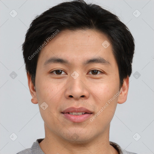 Joyful asian young-adult male with short  brown hair and brown eyes