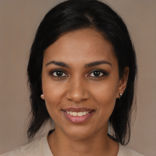 Joyful black young-adult female with medium  brown hair and brown eyes