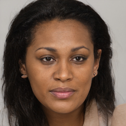 Joyful black young-adult female with long  brown hair and brown eyes