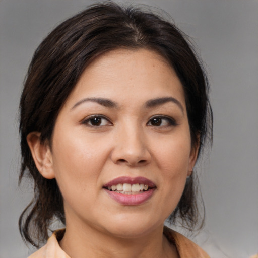 Joyful latino young-adult female with medium  brown hair and brown eyes