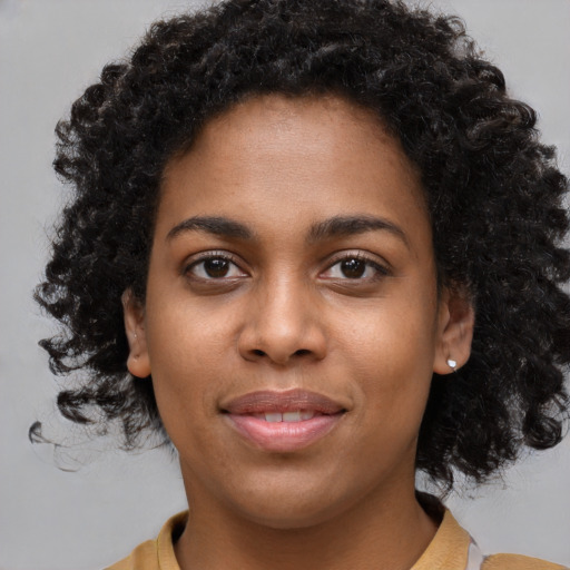 Joyful black young-adult female with short  brown hair and brown eyes
