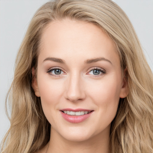 Joyful white young-adult female with long  brown hair and blue eyes