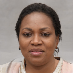 Joyful black adult female with medium  brown hair and brown eyes