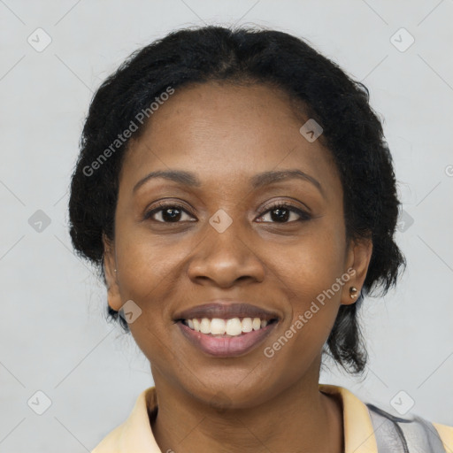 Joyful black young-adult female with long  brown hair and brown eyes