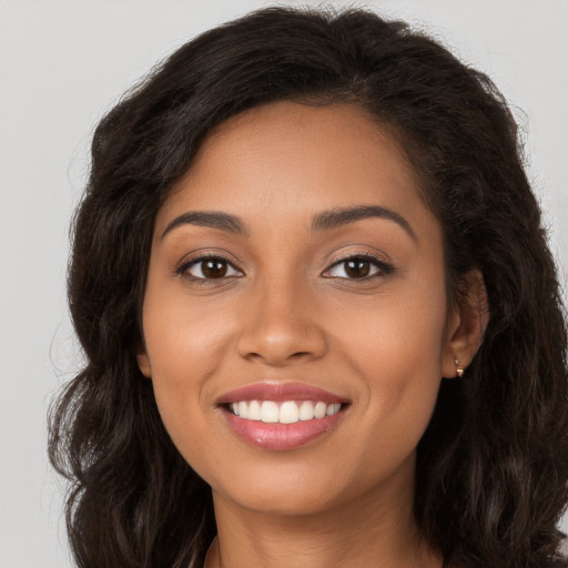 Joyful white young-adult female with long  brown hair and brown eyes