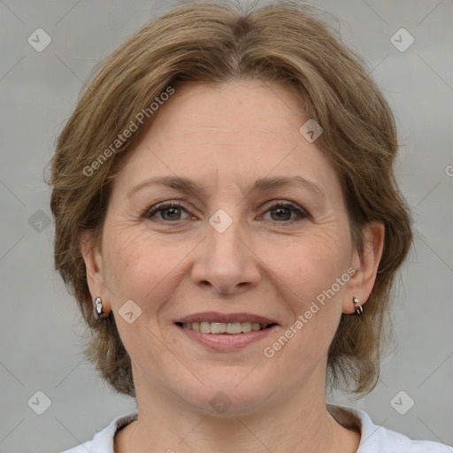 Joyful white adult female with medium  brown hair and brown eyes