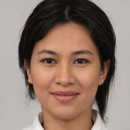 Joyful asian young-adult female with medium  brown hair and brown eyes