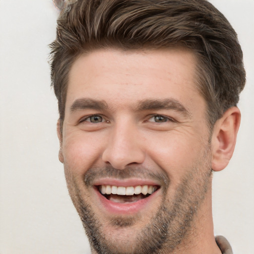 Joyful white young-adult male with short  brown hair and brown eyes