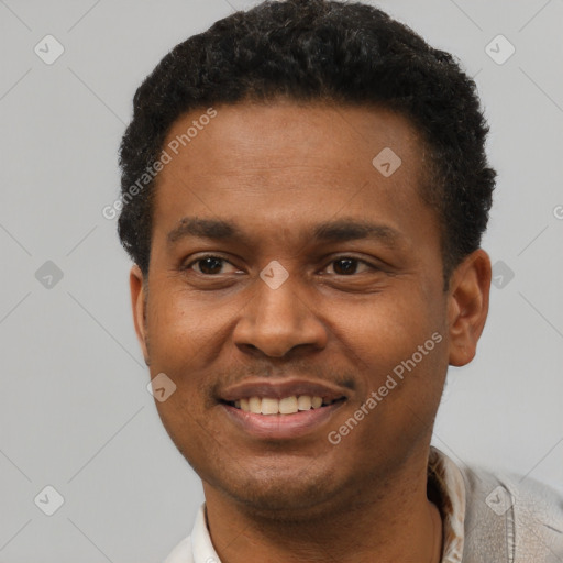 Joyful black young-adult male with short  brown hair and brown eyes