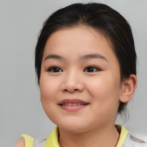 Joyful white child female with medium  brown hair and brown eyes