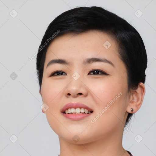 Joyful asian young-adult female with short  black hair and brown eyes