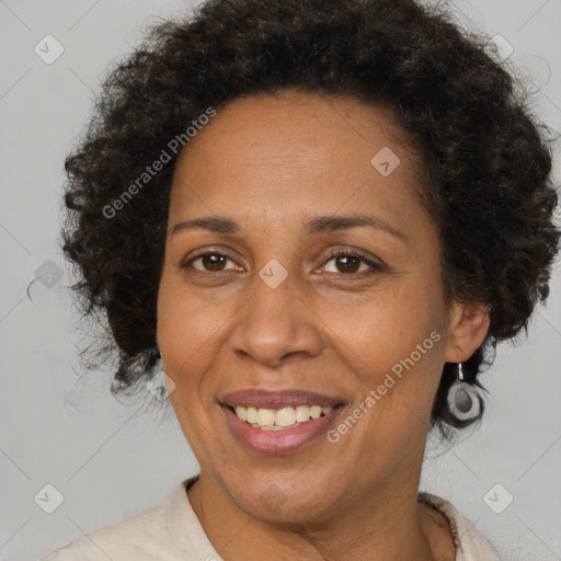 Joyful black adult female with medium  brown hair and brown eyes