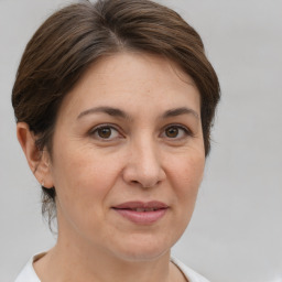 Joyful white adult female with short  brown hair and brown eyes