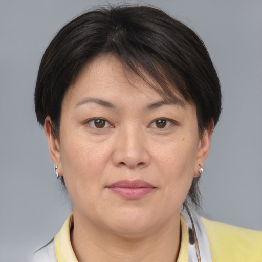Joyful asian adult female with medium  brown hair and brown eyes