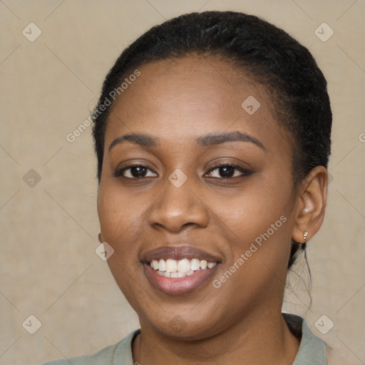 Joyful black young-adult female with short  brown hair and brown eyes