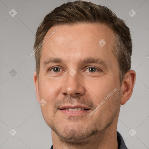 Joyful white adult male with short  brown hair and brown eyes