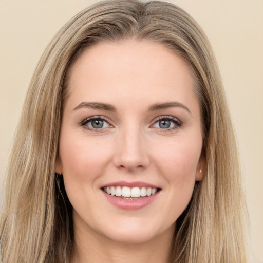 Joyful white young-adult female with long  brown hair and green eyes