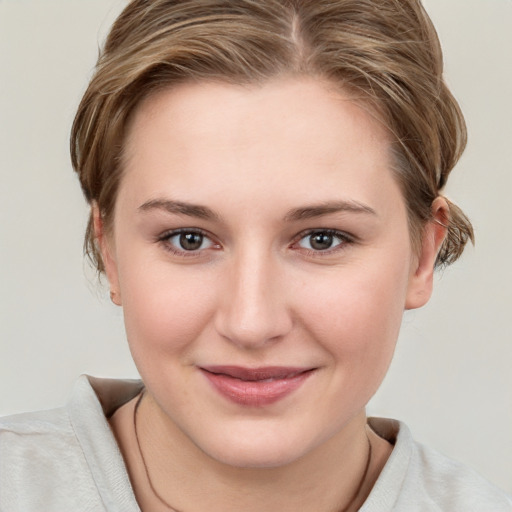 Joyful white young-adult female with medium  brown hair and grey eyes