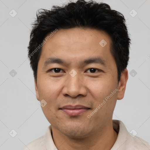 Joyful asian adult male with short  brown hair and brown eyes