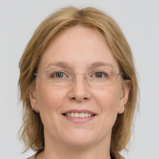 Joyful white adult female with medium  brown hair and grey eyes