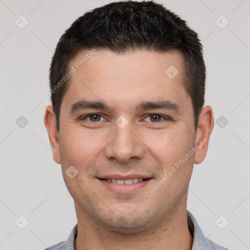 Joyful white young-adult male with short  brown hair and brown eyes