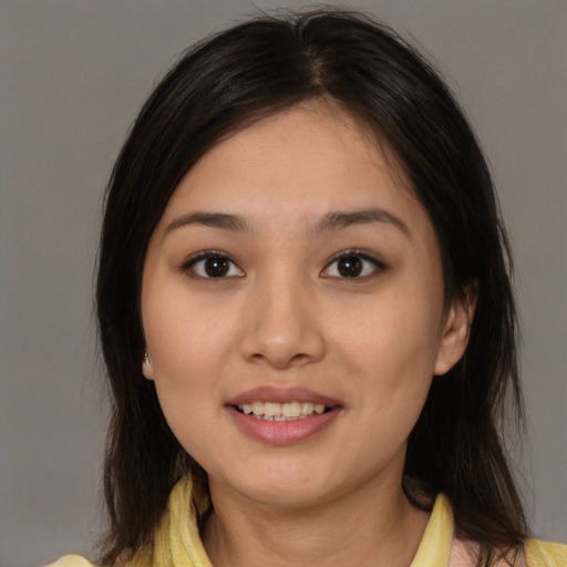 Joyful asian young-adult female with medium  brown hair and brown eyes