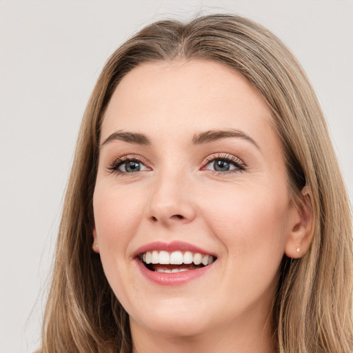 Joyful white young-adult female with long  brown hair and grey eyes