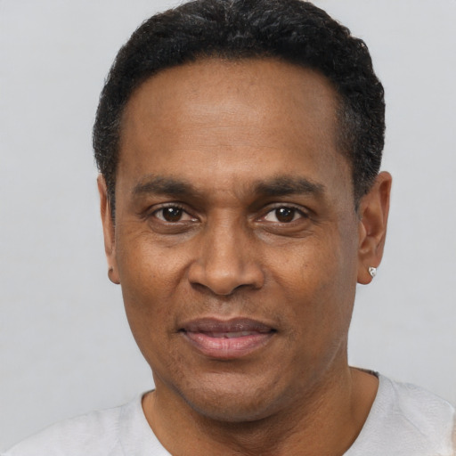 Joyful black adult male with short  black hair and brown eyes