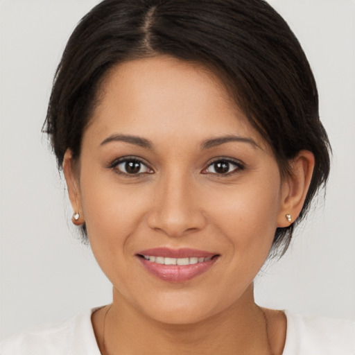 Joyful white young-adult female with medium  brown hair and brown eyes