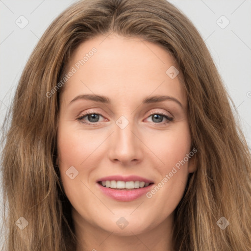 Joyful white young-adult female with long  brown hair and green eyes