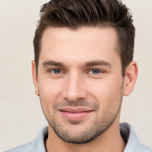 Joyful white young-adult male with short  brown hair and brown eyes