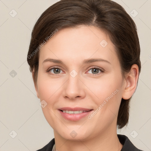 Joyful white young-adult female with short  brown hair and grey eyes