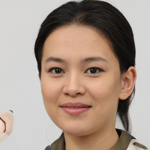 Joyful asian young-adult female with medium  brown hair and brown eyes