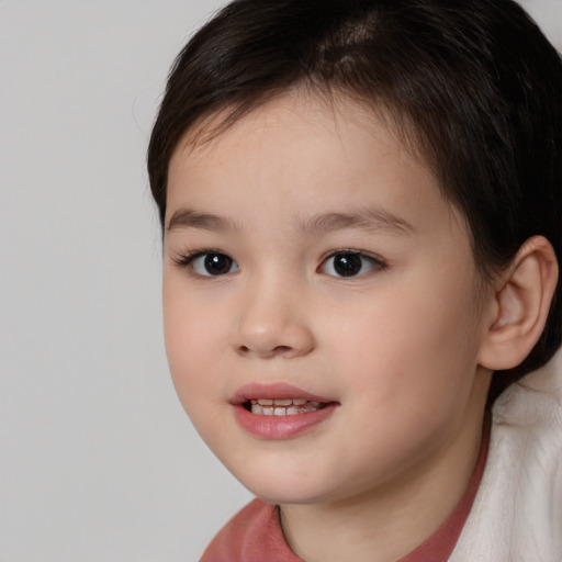 Joyful white child female with short  brown hair and brown eyes