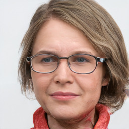 Joyful white adult female with medium  brown hair and blue eyes