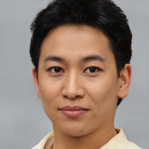 Joyful asian young-adult male with short  brown hair and brown eyes