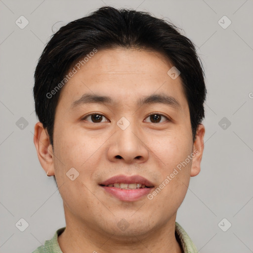 Joyful asian adult male with short  brown hair and brown eyes