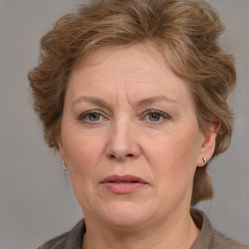 Joyful white adult female with medium  brown hair and grey eyes