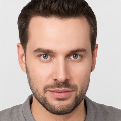 Joyful white young-adult male with short  brown hair and brown eyes