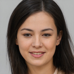 Joyful asian young-adult female with long  brown hair and brown eyes