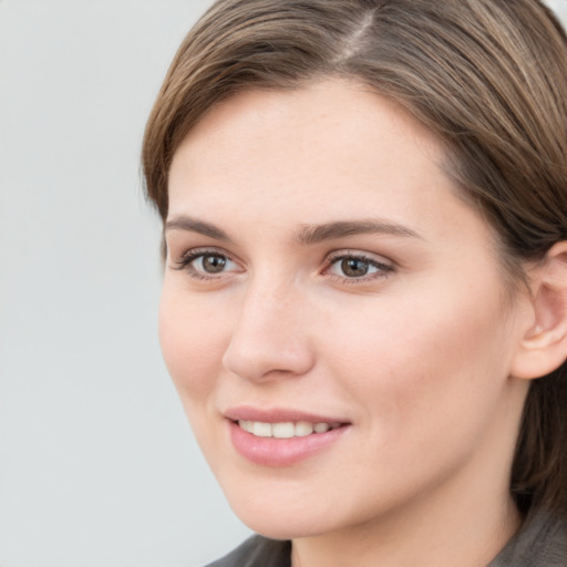 Joyful white young-adult female with medium  brown hair and grey eyes